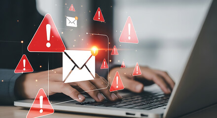 Red warning triangles and email alerts surround hands typing on a laptop danger caution