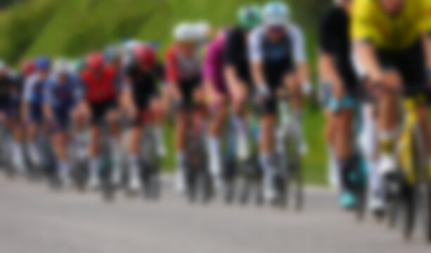 intentionally out of focus group of many cyclists during a competitive road race