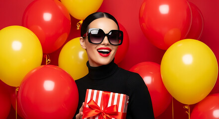 Woman with gift and balloons yellow