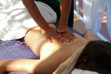 woman covered with white towels during massage session in exclusive luxury spa during cruise