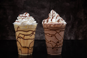 Milkshakes of different flavors on a dark background.
