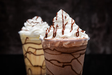 Milkshakes of different flavors on a dark background.