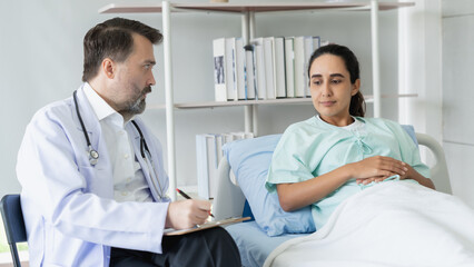 Fototapeta premium Specialist doctors providing medical treatment and discussing test results with patients in a hospital setting. Healthcare and wellness concept.