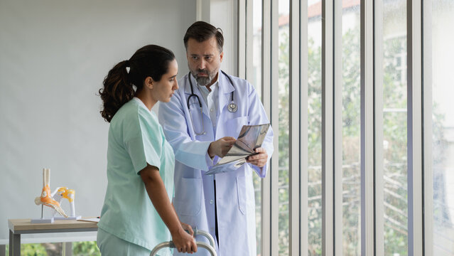 Specialist doctors providing medical treatment and discussing test results with patients in a hospital setting. Healthcare and wellness concept.