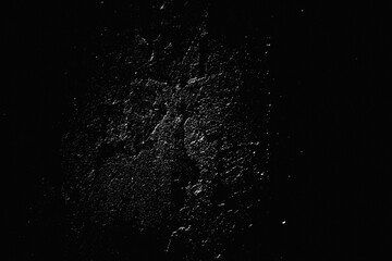 Speckled Rough plastering grunge wall. Shabby grainy noise dusted vintage abstract structure. Grungy surface. Retro gritty effect overlay. Black background