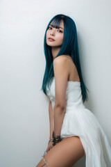 Japanese model posing in white dress and blue hair