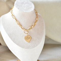 Close up paperclip style chain necklace on neck mannequin engraved monogram initial gold jewelry...
