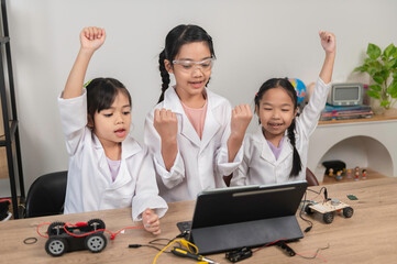 Asian littlle girl constructing and coding robot at STEM class,Fixing and repair mechanic toy car