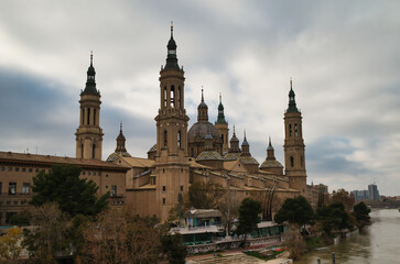 Naklejka premium View of the Cathedral Basilica of Nuestra Señora del Pilar with its four towers, next to the Ebro river, in Zaragoza. Spain