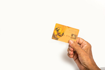 Human hand holding credit card on isolated white background