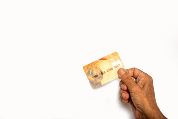Human hand holding credit card on isolated white background