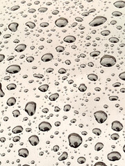 Water droplets on glass surface close-up background