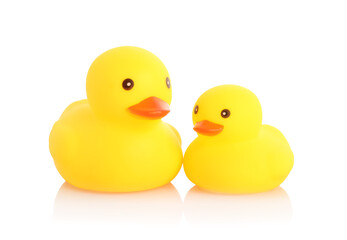 Cute rubber ducks on mirror surface against white background