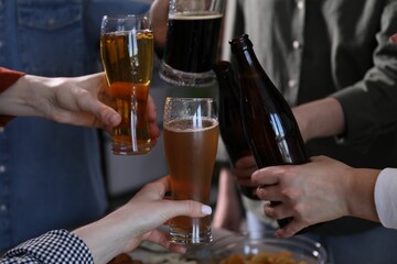 Friends having refreshing beer at home, closeup