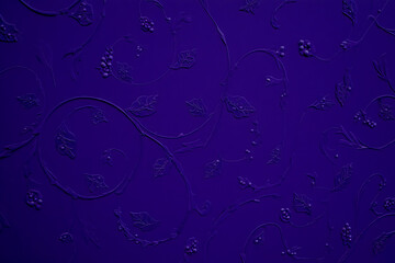Deep indigo embossed floral pattern with swirling vines and berries
