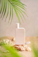 Sunblock or sunscreen in cosmetic tube on beach sand and beige background. Summer vacation and skin care concept with starfish and sea shells, spf uv-protect cosmetics. Skin health. High quality photo