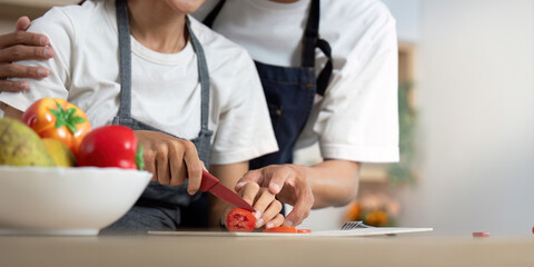 Couple in Kitchen. Partners enjoying cooking together while preparing fresh ingredients.