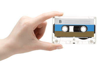 Woman holding audio cassette with blank label on white background, closeup