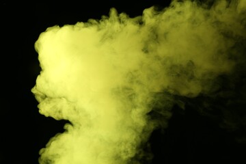 Hookah smoke in yellow light on black background, closeup