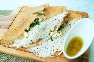 Classic French savory crepe stuffed with chicken, spinach and cheese served with olive oil