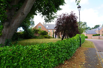 Nottinghamshire, England - June 20 2025: Charming suburban scene showcasing a red brick house,...