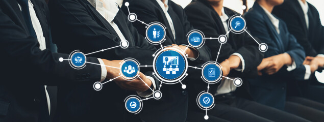 A dynamic scene showcasing professionals in suits at a business conference, surrounded by graphical icons symbolizing key aspects of management and teamwork. Amity