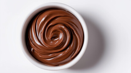A top-down view of a white bowl filled with glossy, swirled chocolate cream or mousse, centered on a pristine white background.
