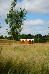 Nottinghamshire, England - June 20 2025: Unique round wooden structure in a scenic rural landscape...
