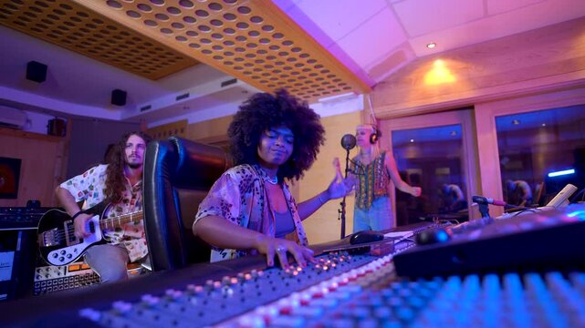 Music producer working at mixing console in recording studio