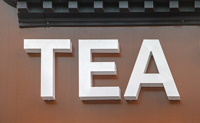Large White 3d Sign Tea at Brown Building