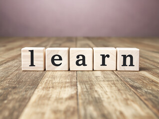 Learn spelled with wooden blocks, education concept on rustic background
