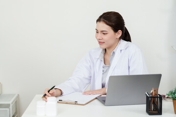 Asian orthopedic doctor writes treatment notes during elderly patient consultation, focusing on bone and joint symptoms, inside modern hospital examination room with medicine bottles on table