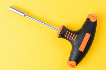 Holder for hex socket bits on bright yellow background metal tool set top view