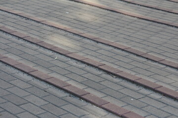 Weathered wooden boardwalk planks with metal strips creating linear pattern and rustic texture