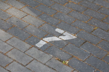 Damaged concrete paving stones with broken pieces scattered on urban walkway surface