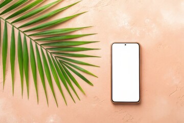 Smartphone with a palm frond on a textured peach background