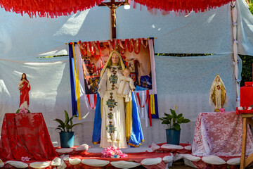 Colorful altar decorated with images of Catholic saints and the Virgin Mary