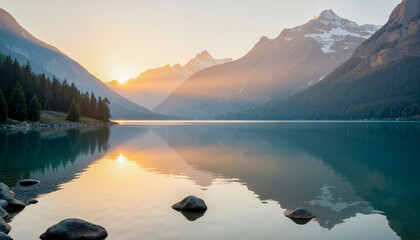 Serene mountain lake reflection at golden sunrise with misty peaks
