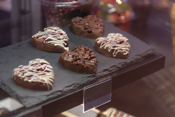 Delicious heart-shaped chocolates displayed in a cozy shop setting
