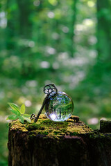 vintage key and quartz crystal ball in forest, natural background. occultism, magic ritual, witchcraft. wiccan esoteric spiritual practice. fairytale, mystery atmosphere
