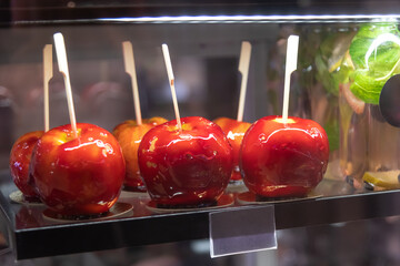 Bright red candy apples displayed in a dessert shop at a fall festival
