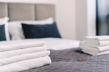Modern hotel suite with cozy bedding and neatly arranged towels for a perfect morning