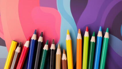 Vibrant colored pencils lined up against a colorful abstract background, showcasing creativity and art supplies