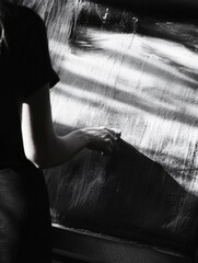 A woman is writing on a chalkboard with a chalk