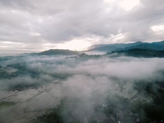 Misty sunrise over mountain valley.