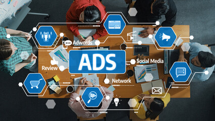 A diverse team collaborates in a modern workspace, focusing on advertising strategies and digital marketing solutions, using technology and analytics for effective campaigns. Amity