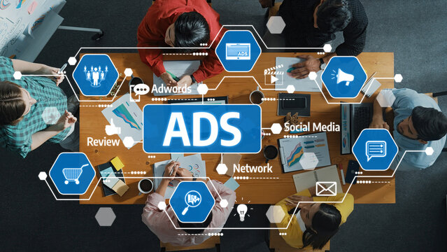 A diverse team collaborates in a modern workspace, focusing on advertising strategies and digital marketing solutions, using technology and analytics for effective campaigns. Amity - Powered by Adobe