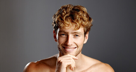 Man, skin care and hand on chin in portrait for confidence, beard and dermatology on a grey...