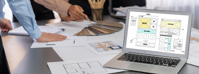 Group of interior architect designer discussing together on blueprint and laptop screen display...