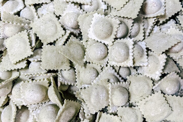 Homemade ravioli made with spinach dough ready for cooking in a cozy kitchen environment